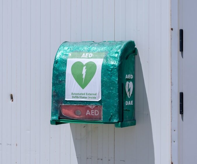 a green mailbox attached to a white wall